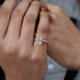 Diamond ring held by a hand 