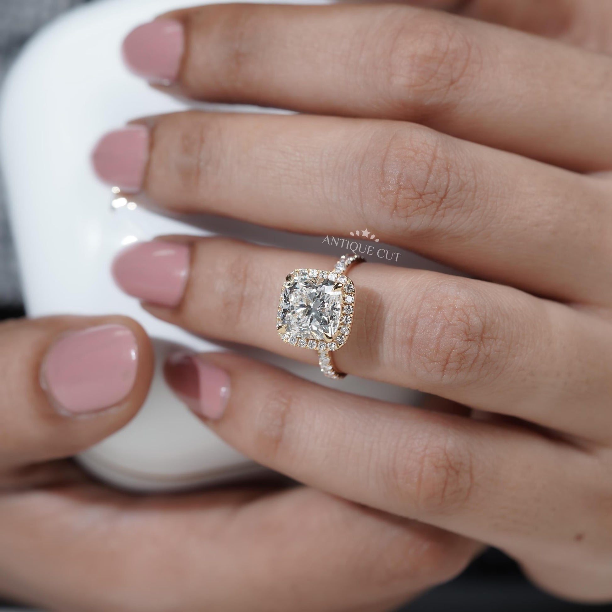 Cushion diamond halo ring side view yellow gold