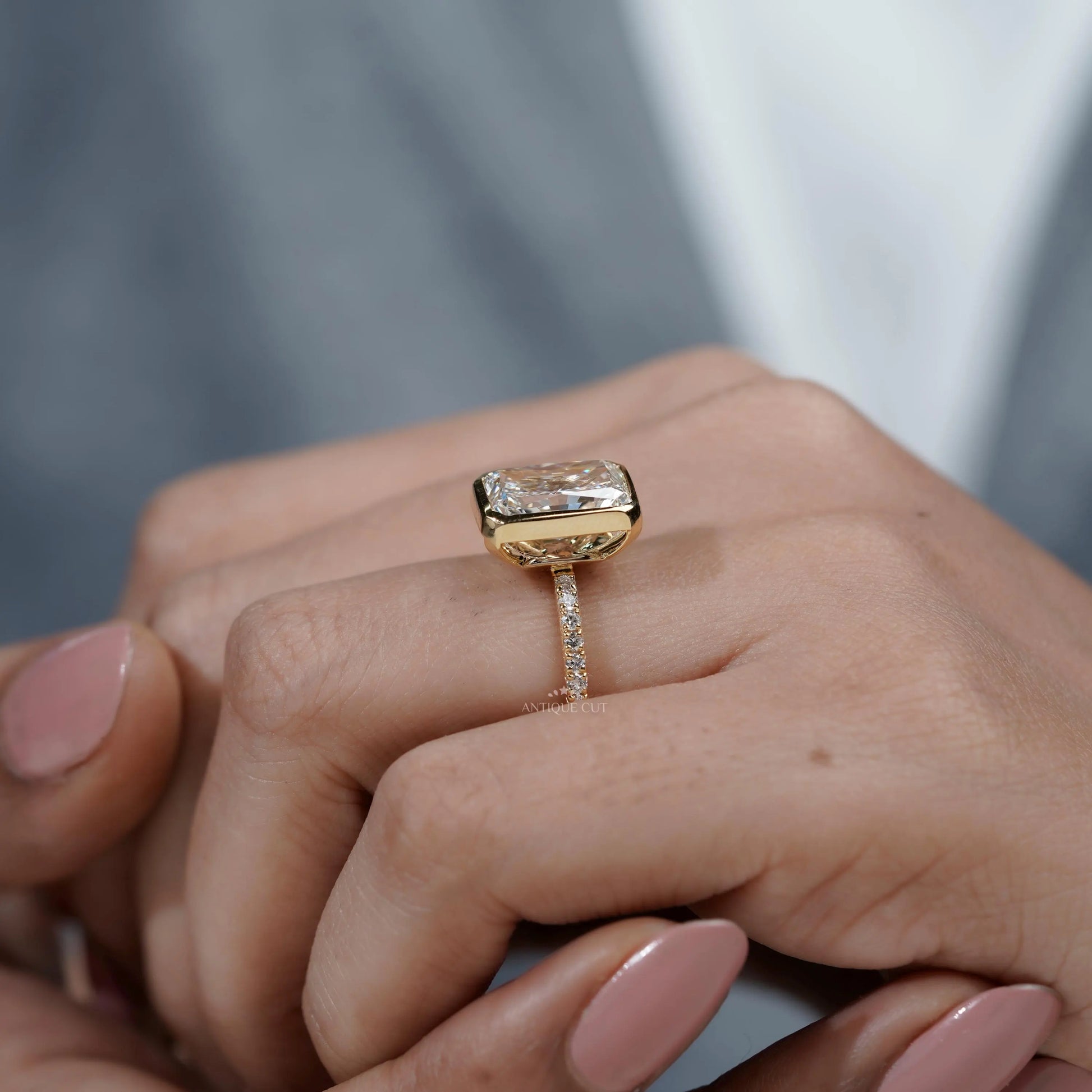 Gold ring with a large diamond on a hand

