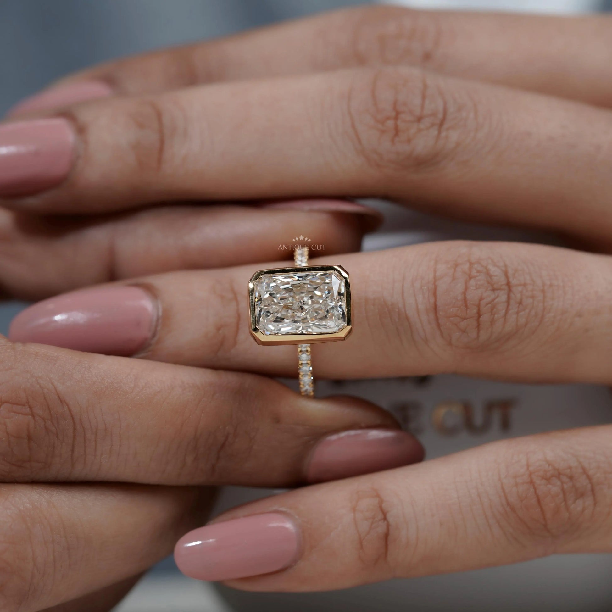 Gold ring with a large diamond on a hand

