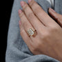 Gold ring with a large diamond on a hand

