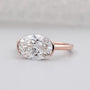 Rose gold ring with a large diamond on a light gray background