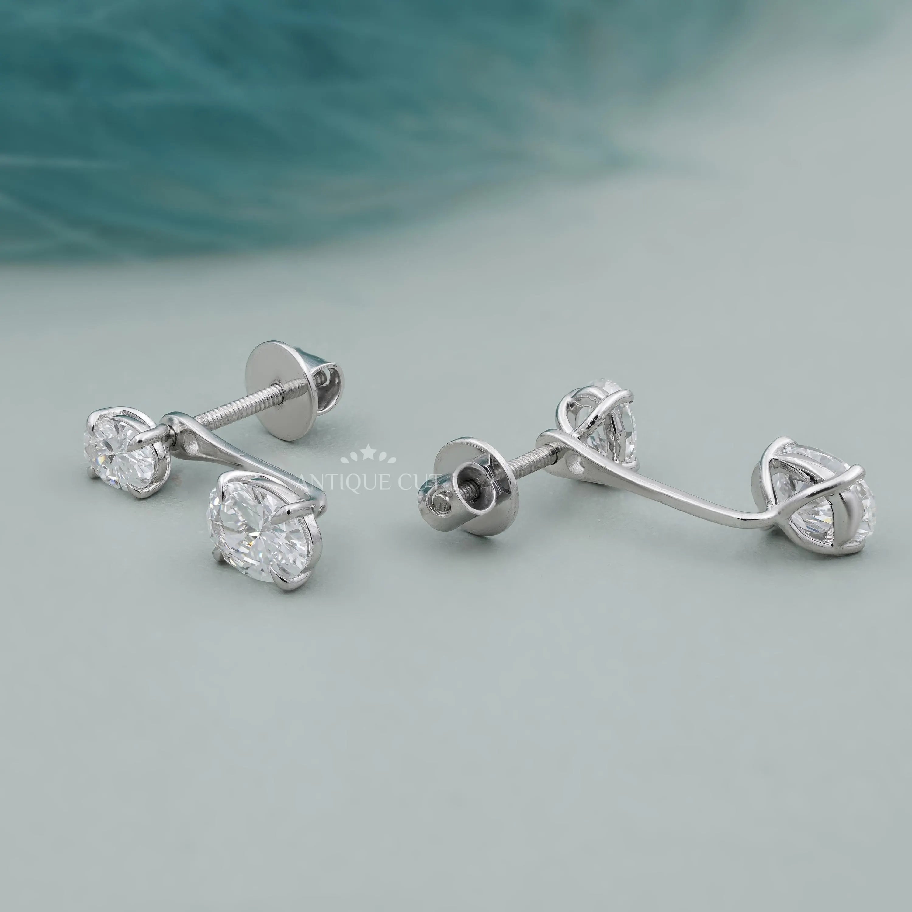 Pair of silver earrings on a light gray background