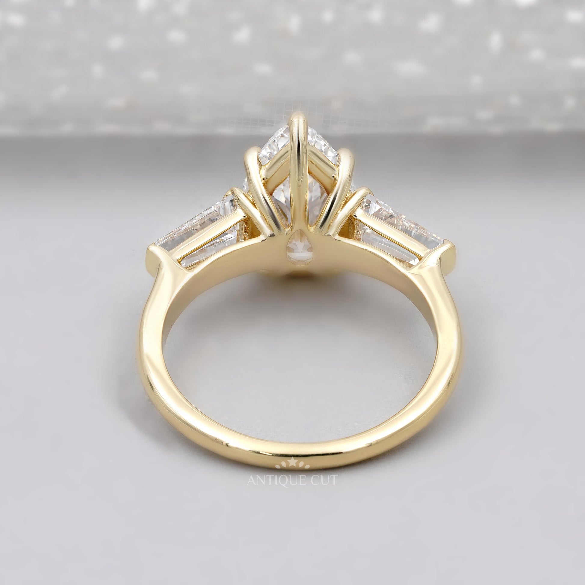 Elegant pear diamond engagement ring with tapered side stones