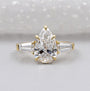 Three stone pear engagement ring in yellow gold