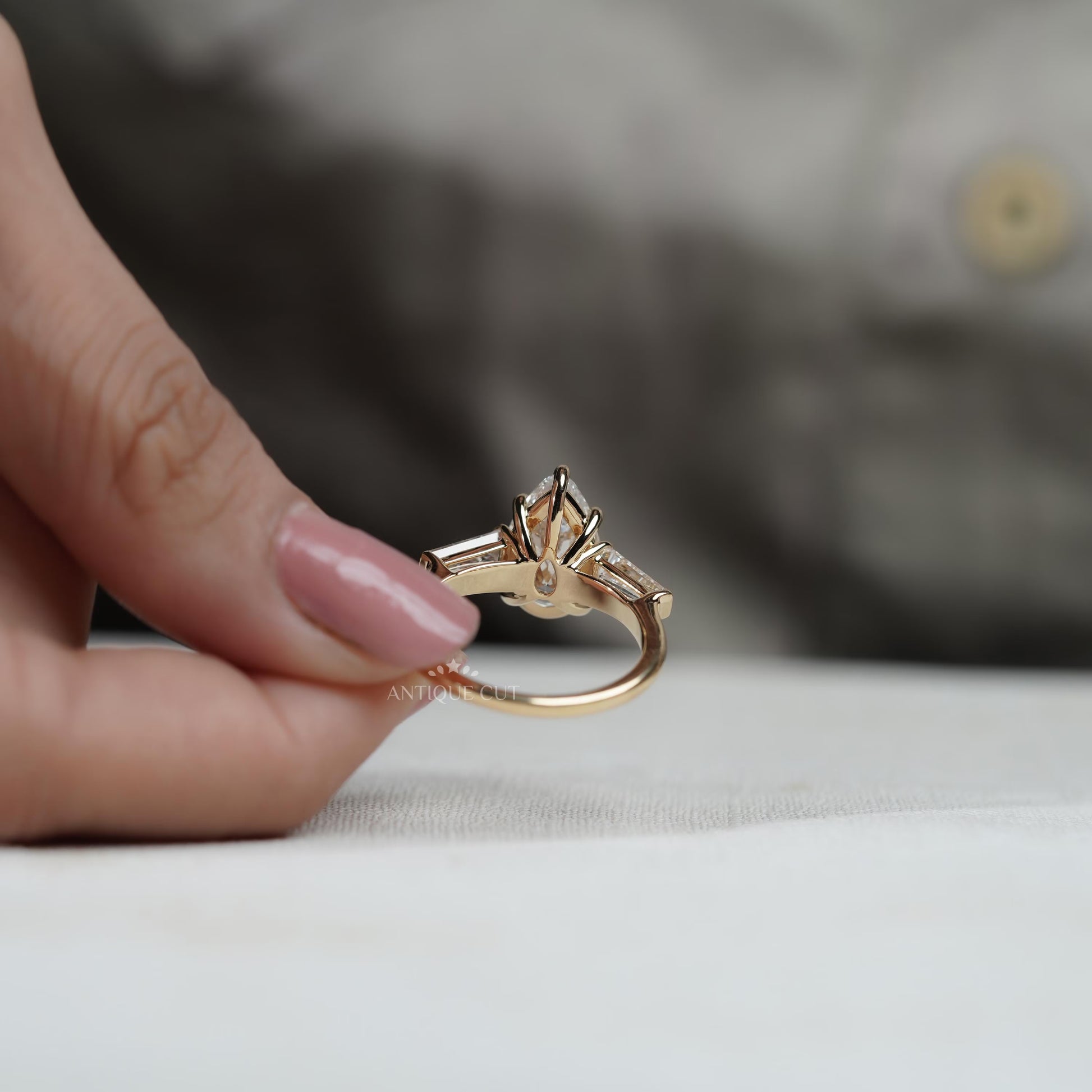 Timeless pear diamond three stone engagement ring
