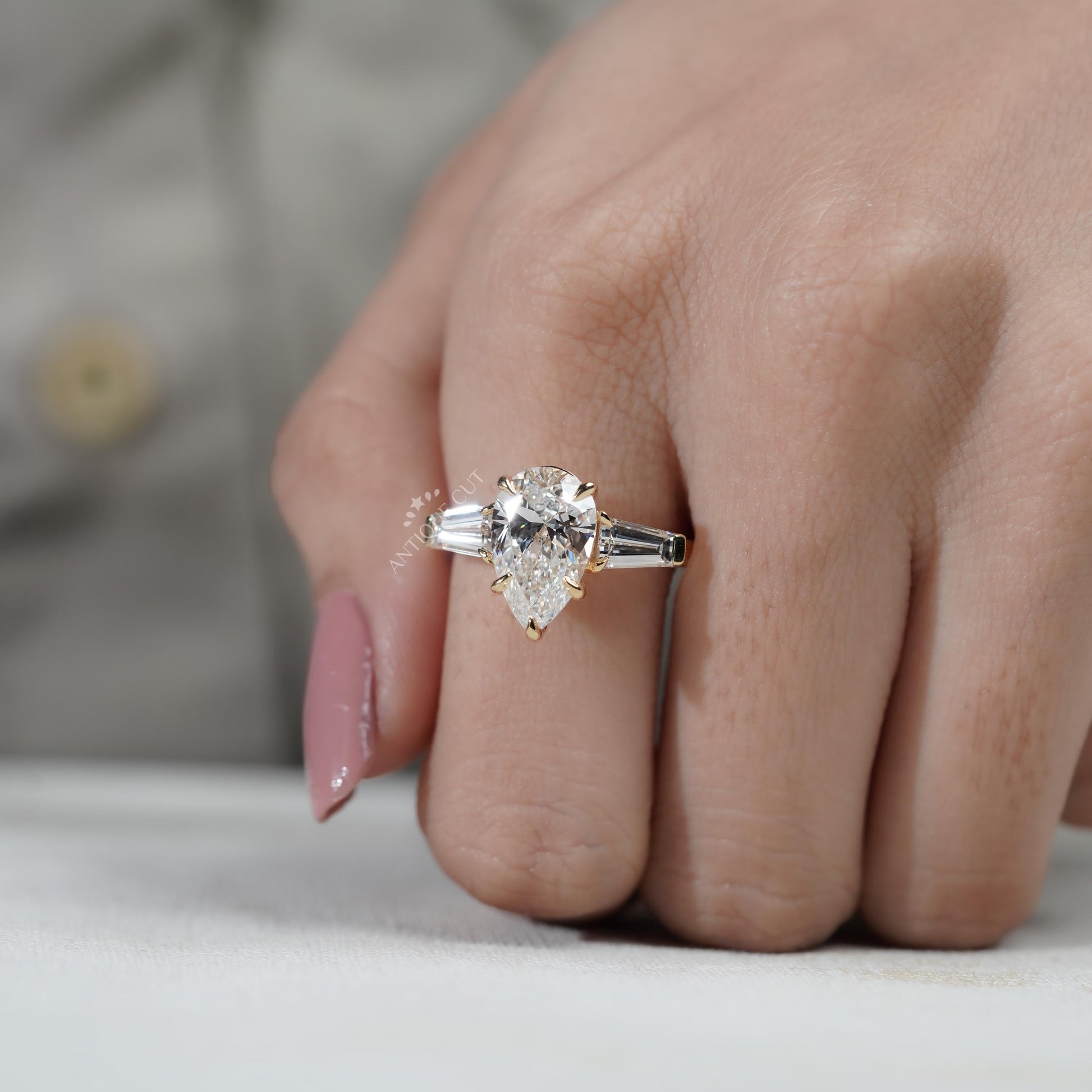 Yellow gold pear diamond ring side view