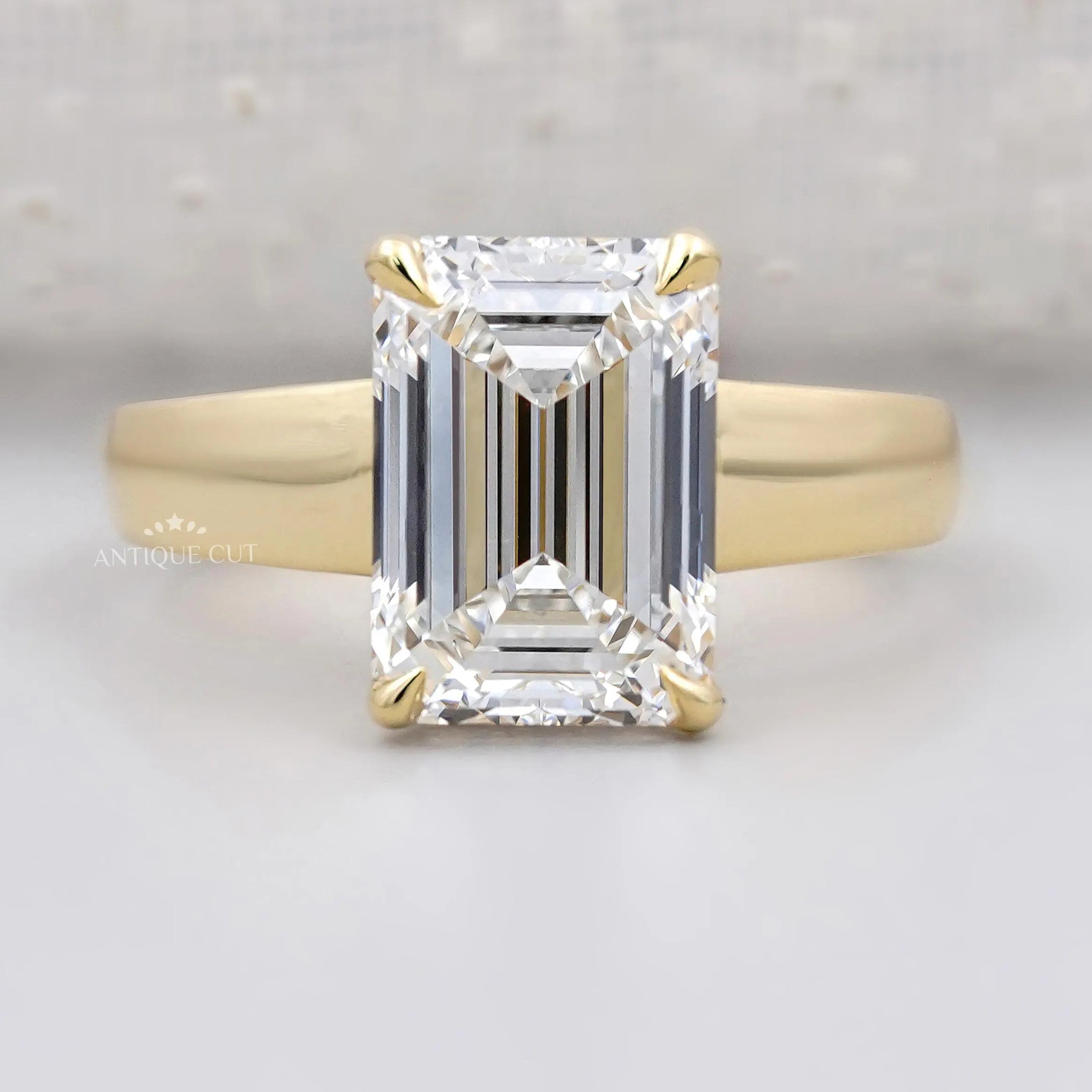 Hidden halo emerald cut engagement ring in yellow gold