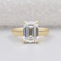 Hidden halo emerald cut engagement ring in yellow gold