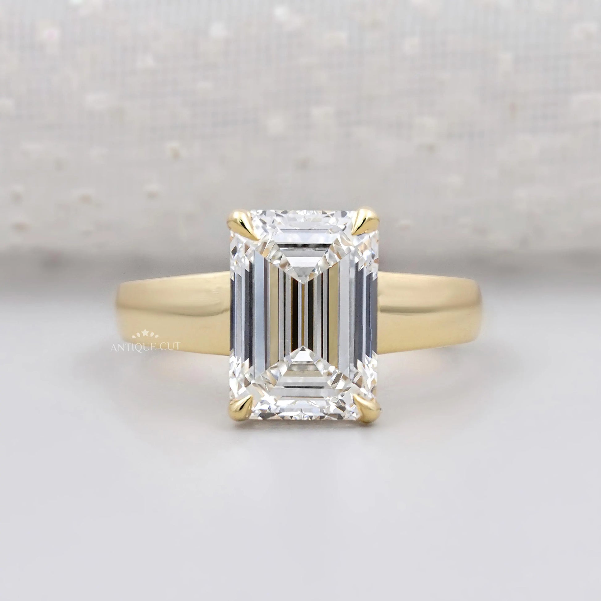 Hidden halo emerald cut engagement ring in yellow gold