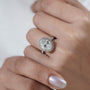 Diamond ring on a hand with a plain background

