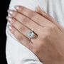 Diamond ring on a hand with a plain background

