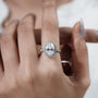 Diamond ring on a hand with a plain background

