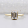 Emerald solitaire engagement ring in yellow gold