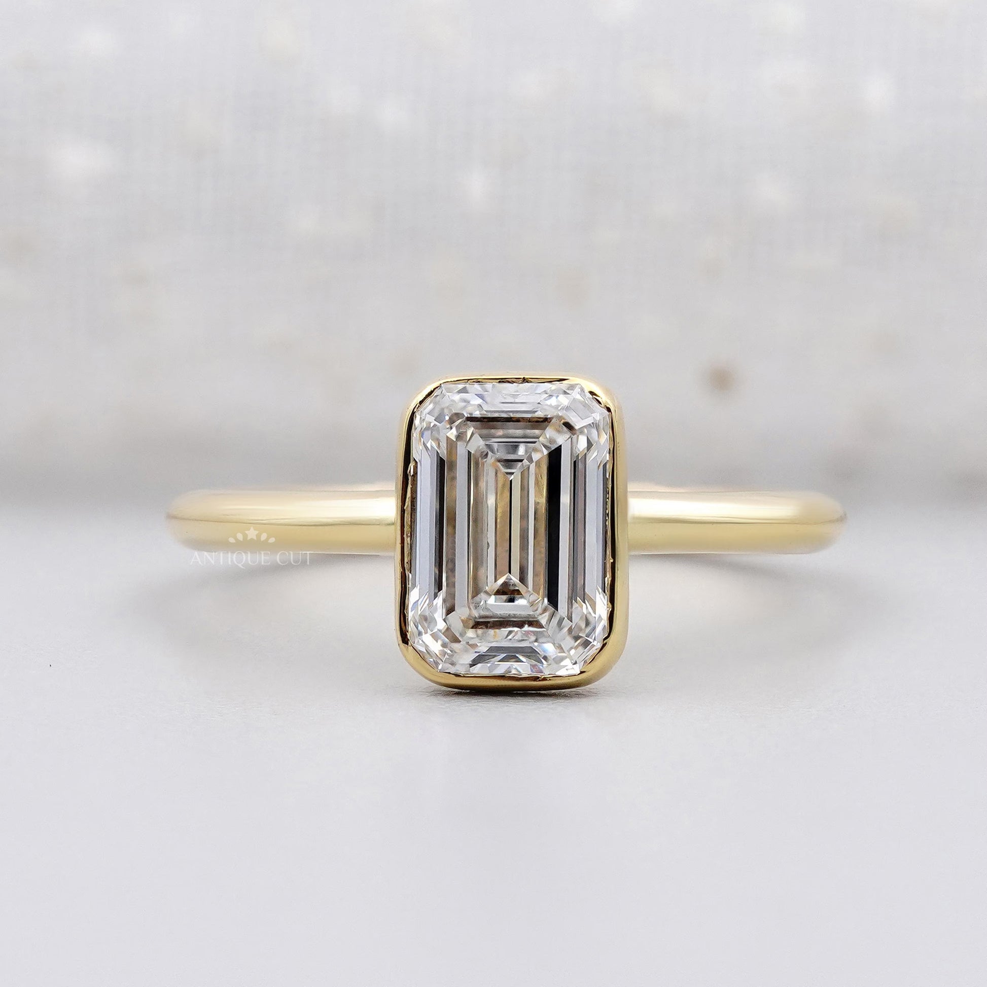 Emerald solitaire engagement ring in yellow gold