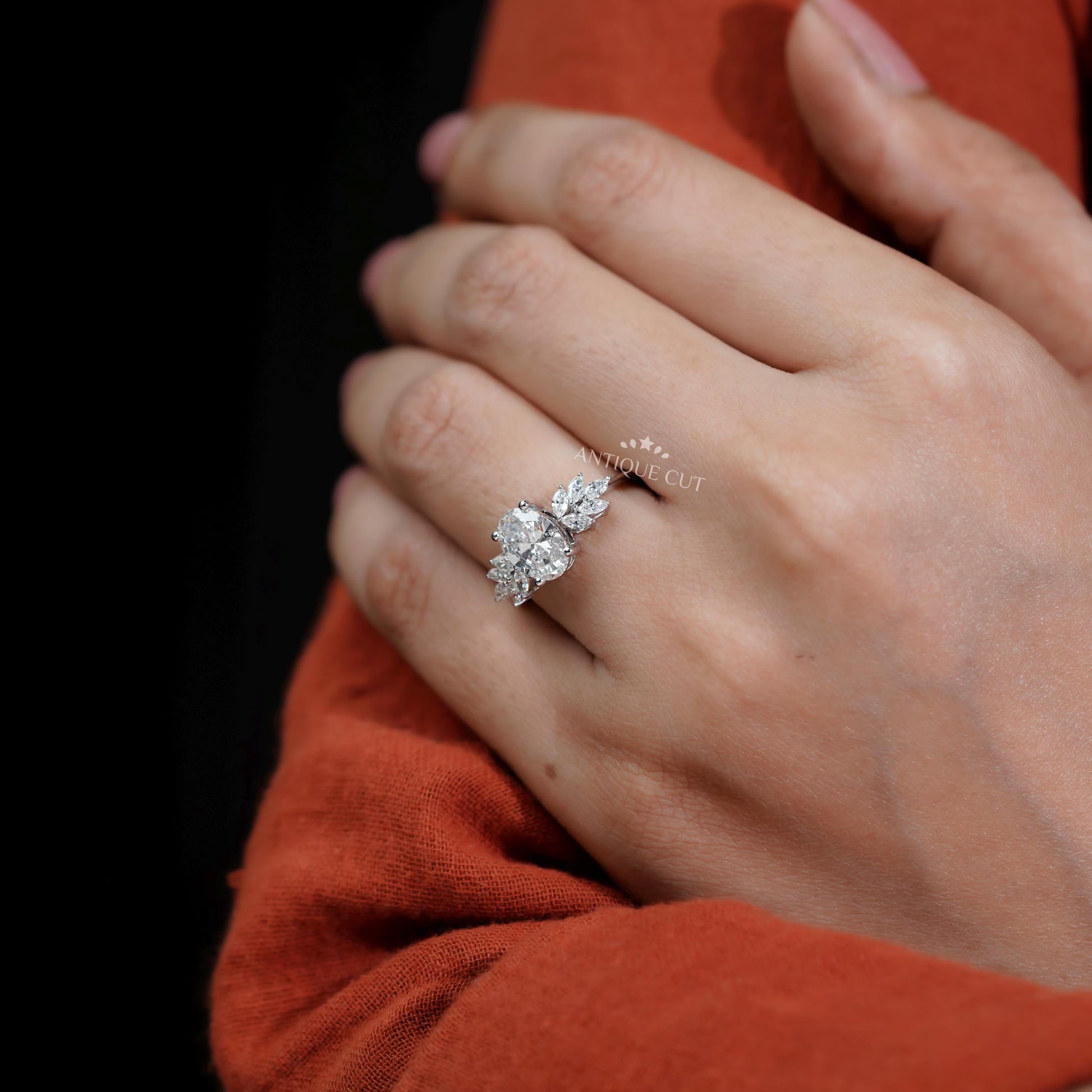 Diamond ring on a finger with 'AntiqueCut' text