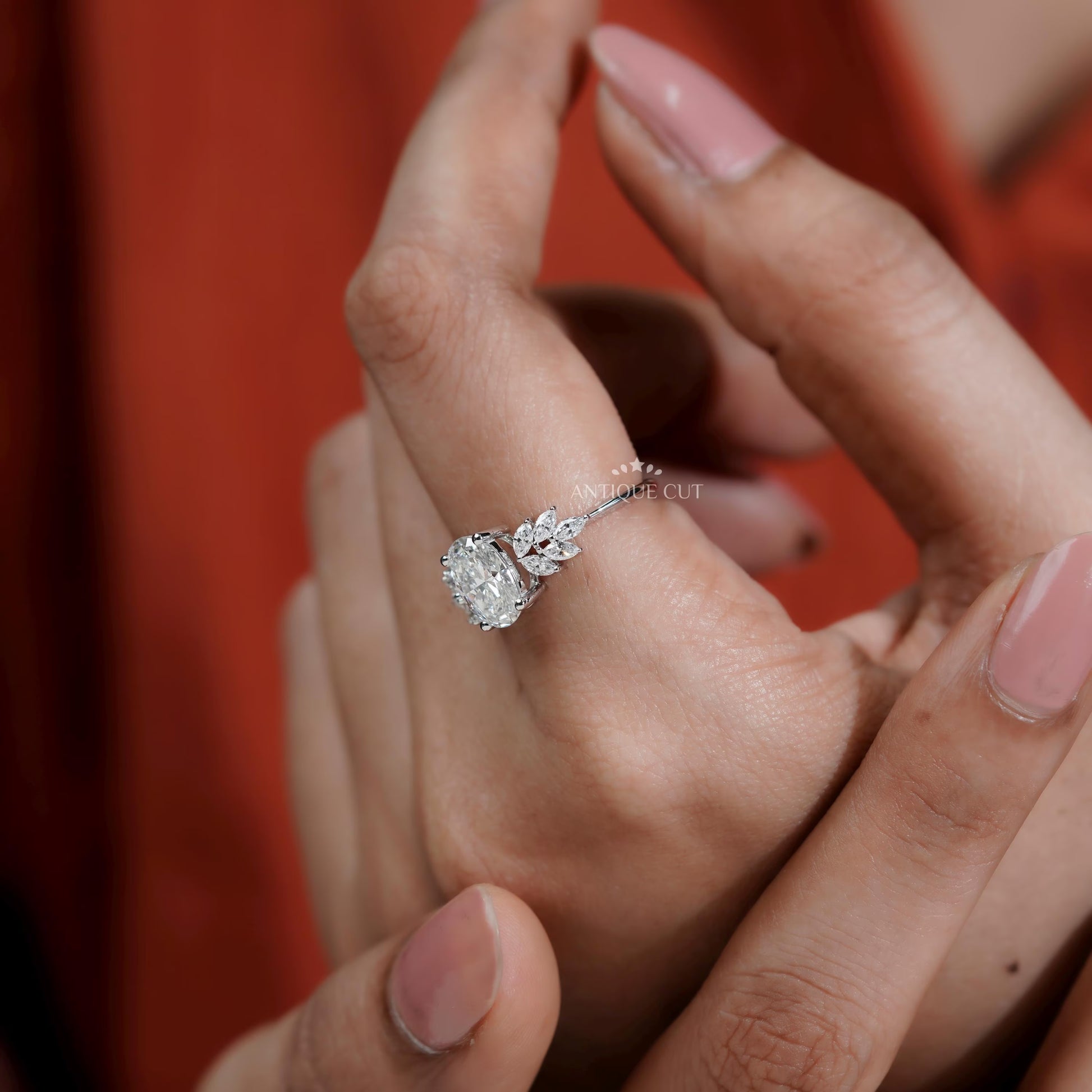 Diamond ring on a finger with 'AntiqueCut' text