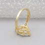 Gold ring with a large diamond on a gray background