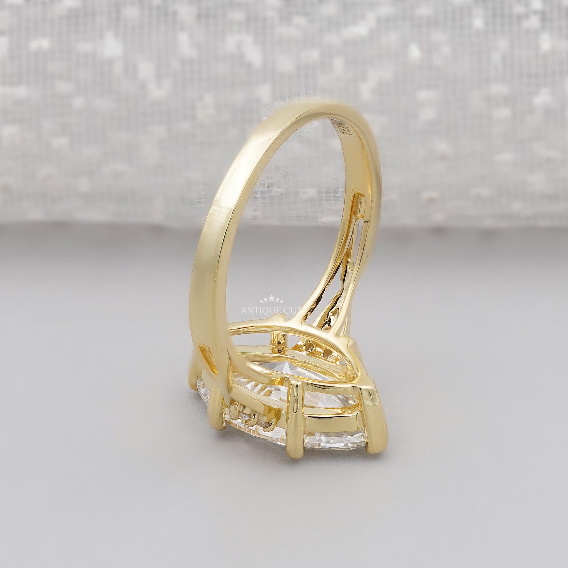 Gold ring with a large diamond on a gray background