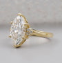 Gold ring with a large diamond on a gray background