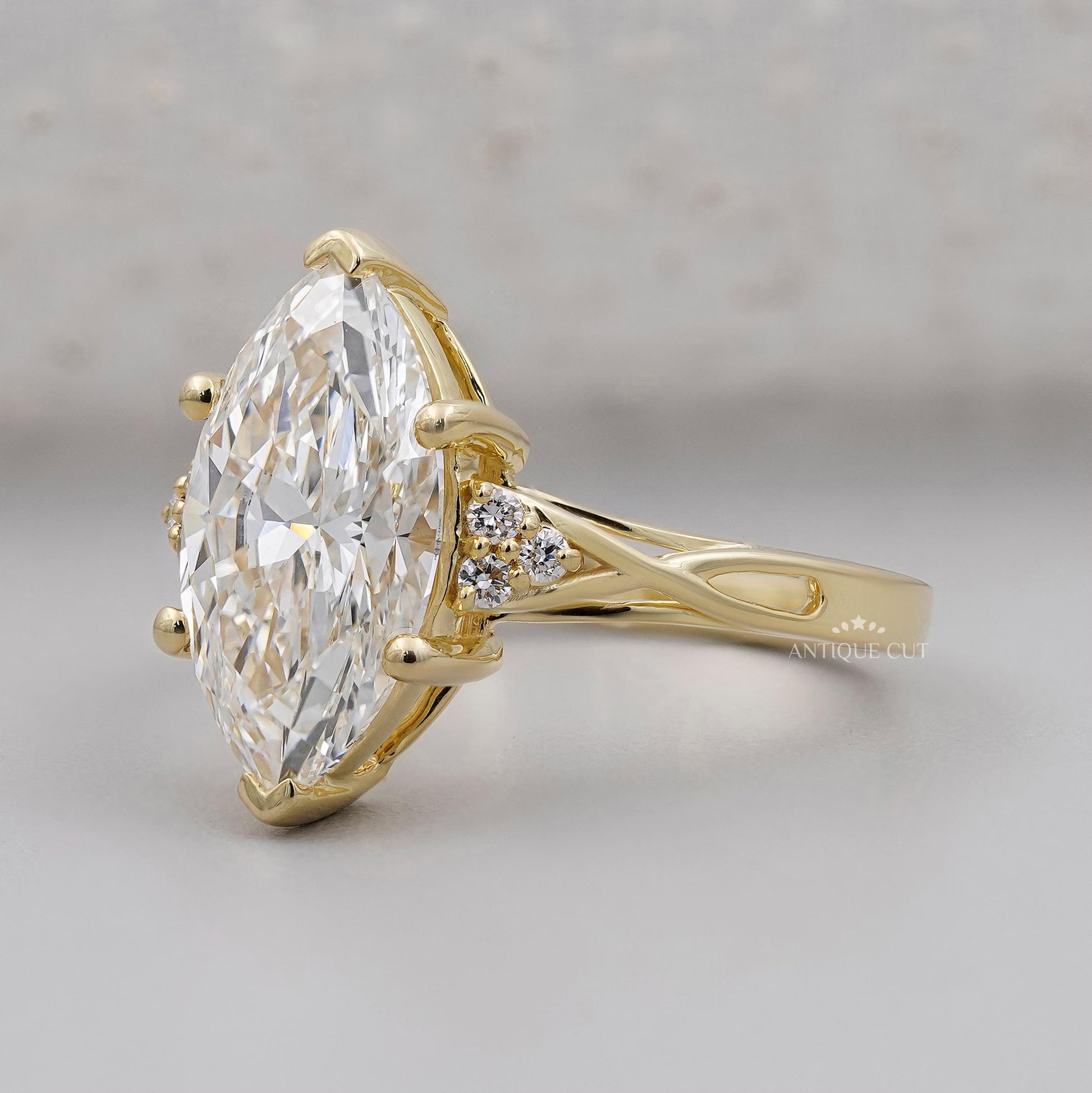 Gold ring with a large diamond on a gray background