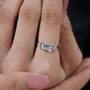 Bezel set emerald cut engagement ring in white gold
