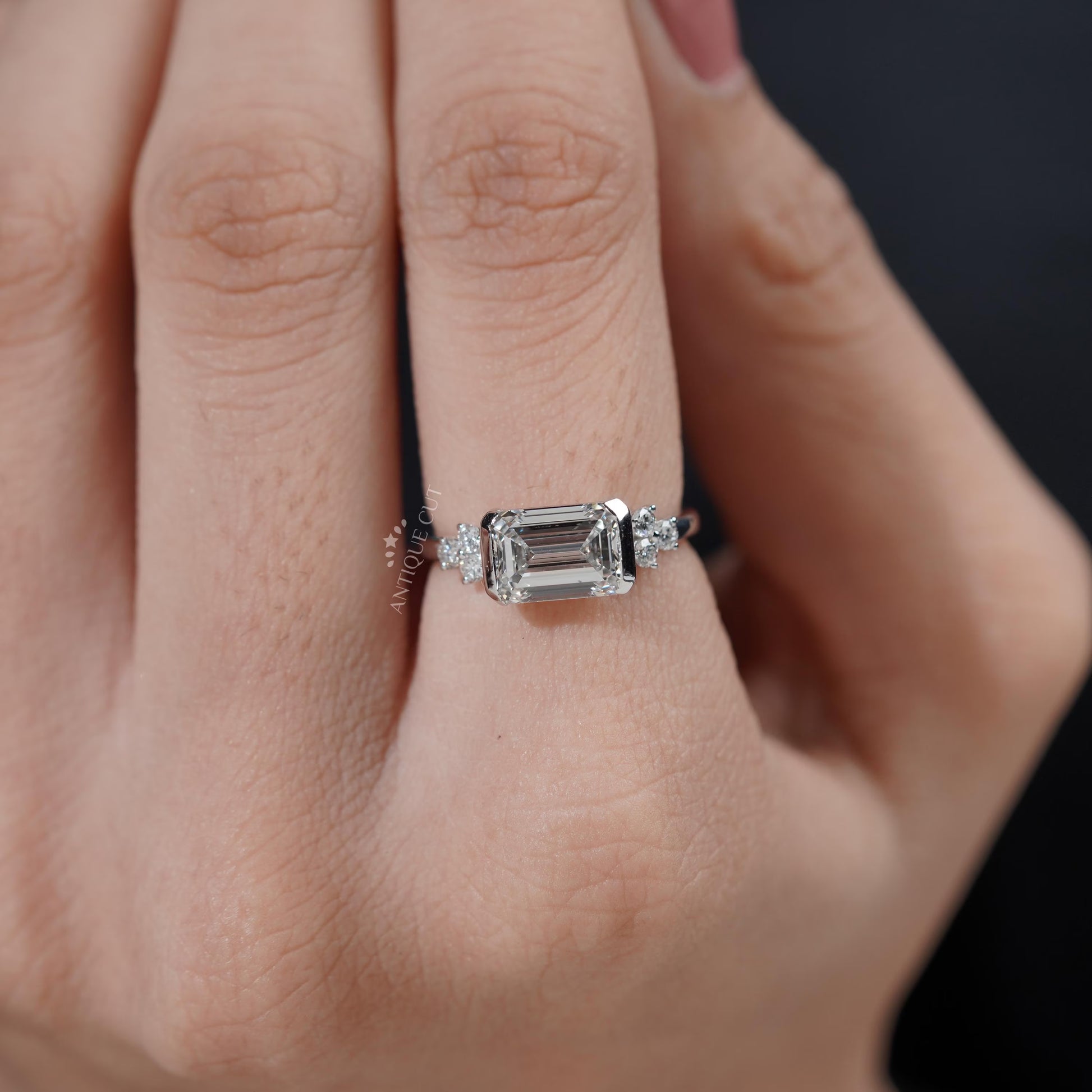 Diamond ring on a finger with a blurred background

