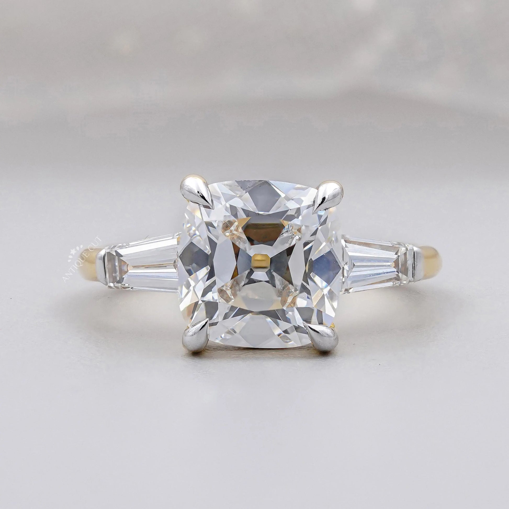 Old mine cushion cut engagement ring three stones yellow gold