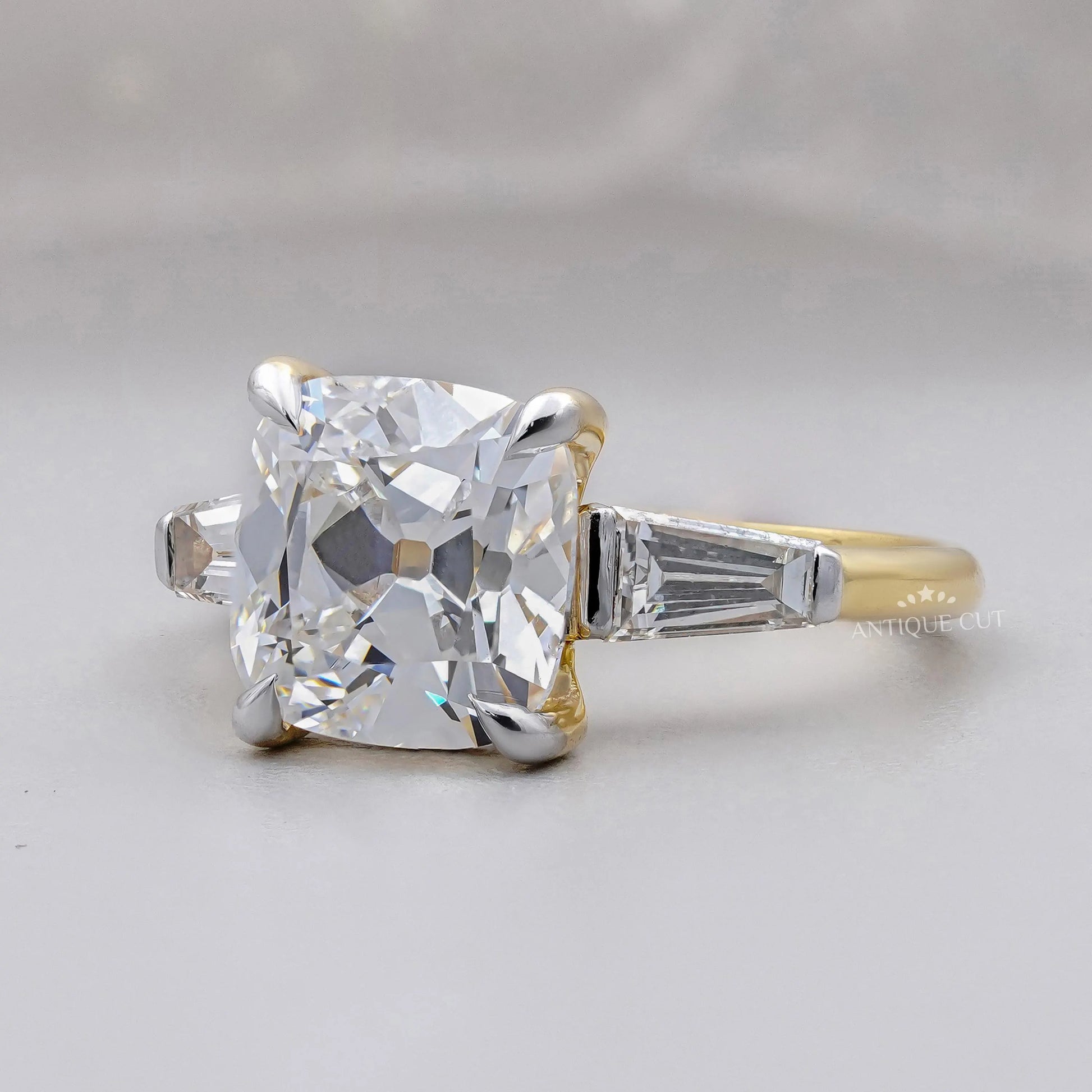 Yellow gold old mine cushion cut three stone ring
