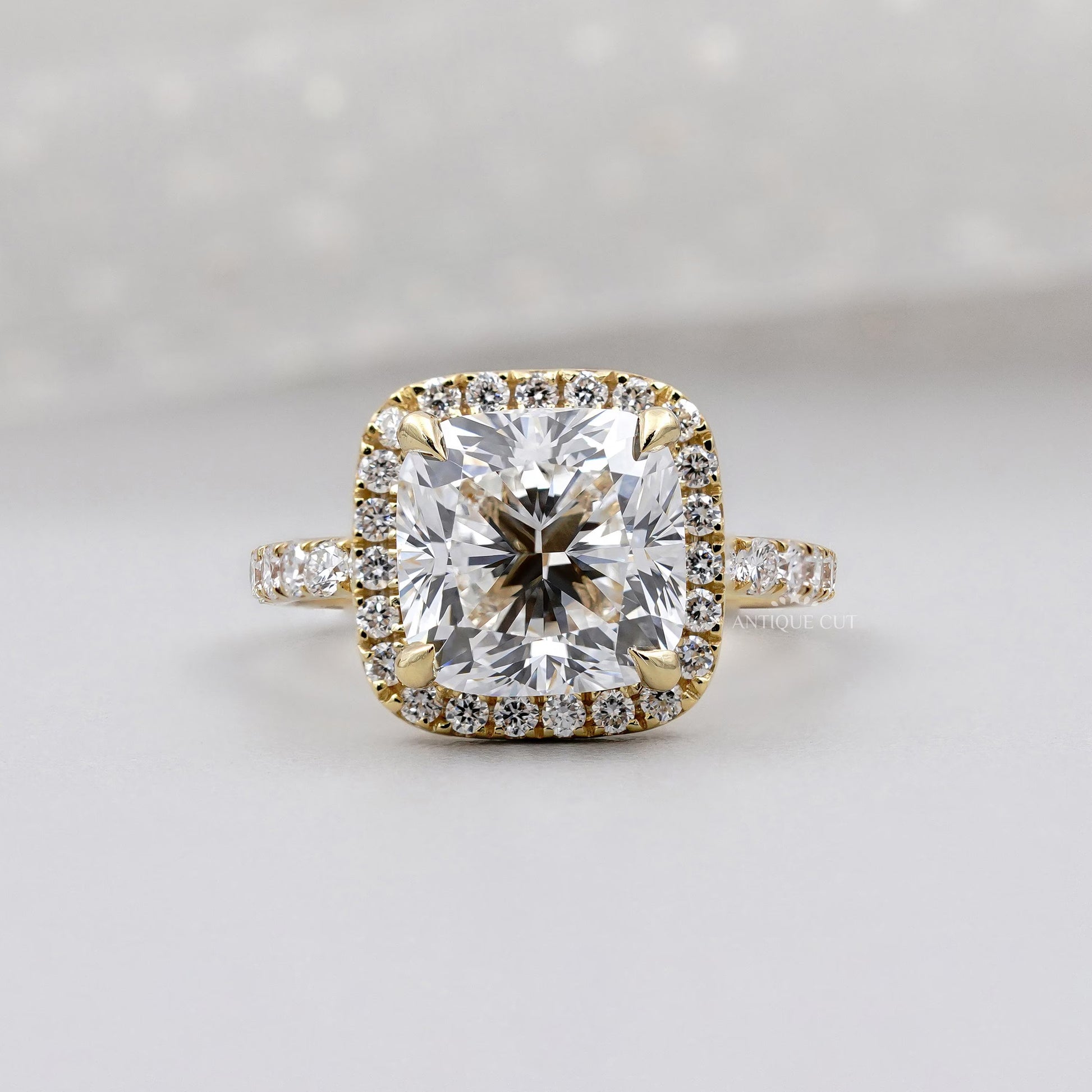 Cushion cut halo diamond engagement ring in yellow gold