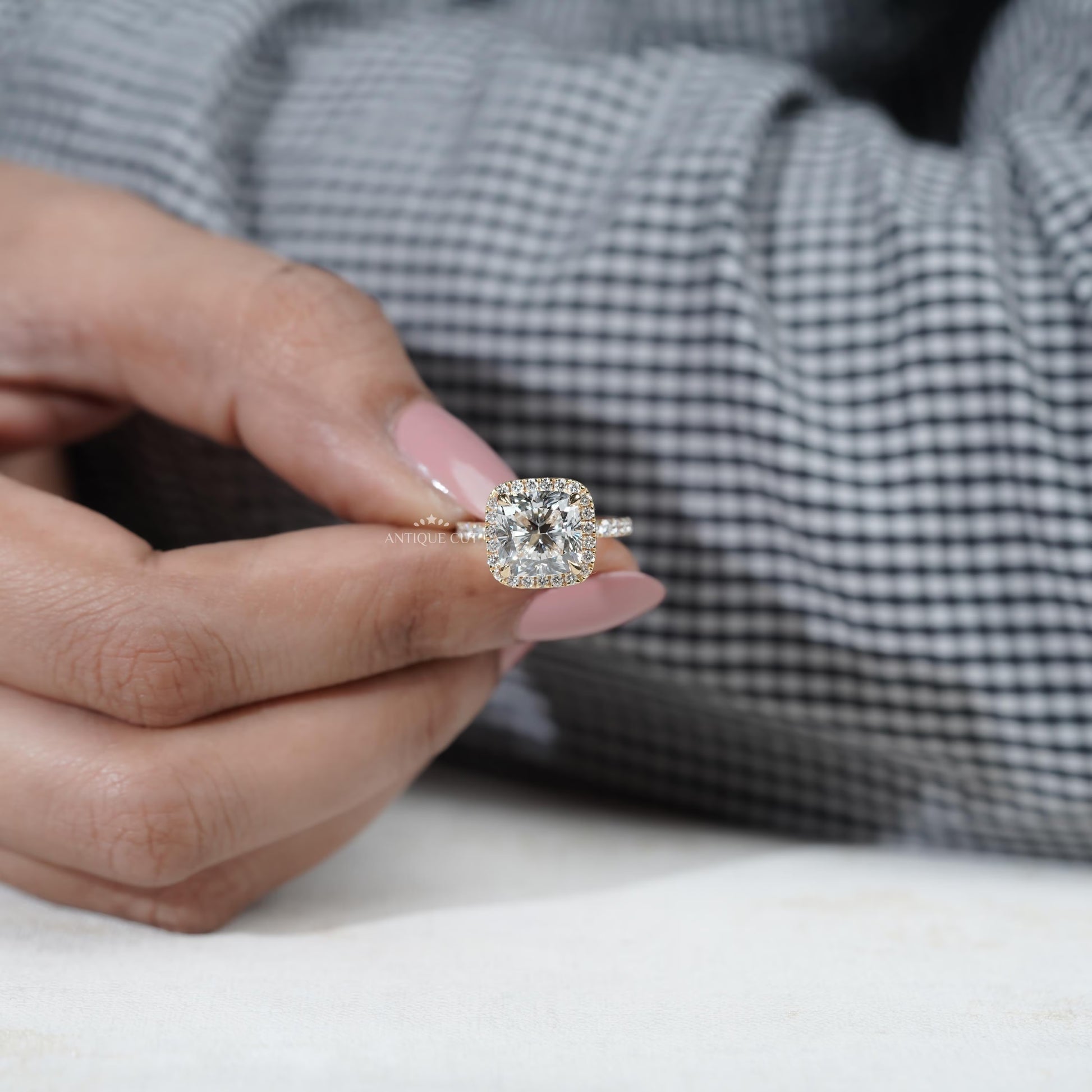 Brilliant cushion cut halo engagement ring with pave band