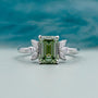 Emerald cut light green engagement ring with side stones