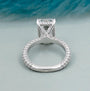 Emerald cut engagement ring with round side stones