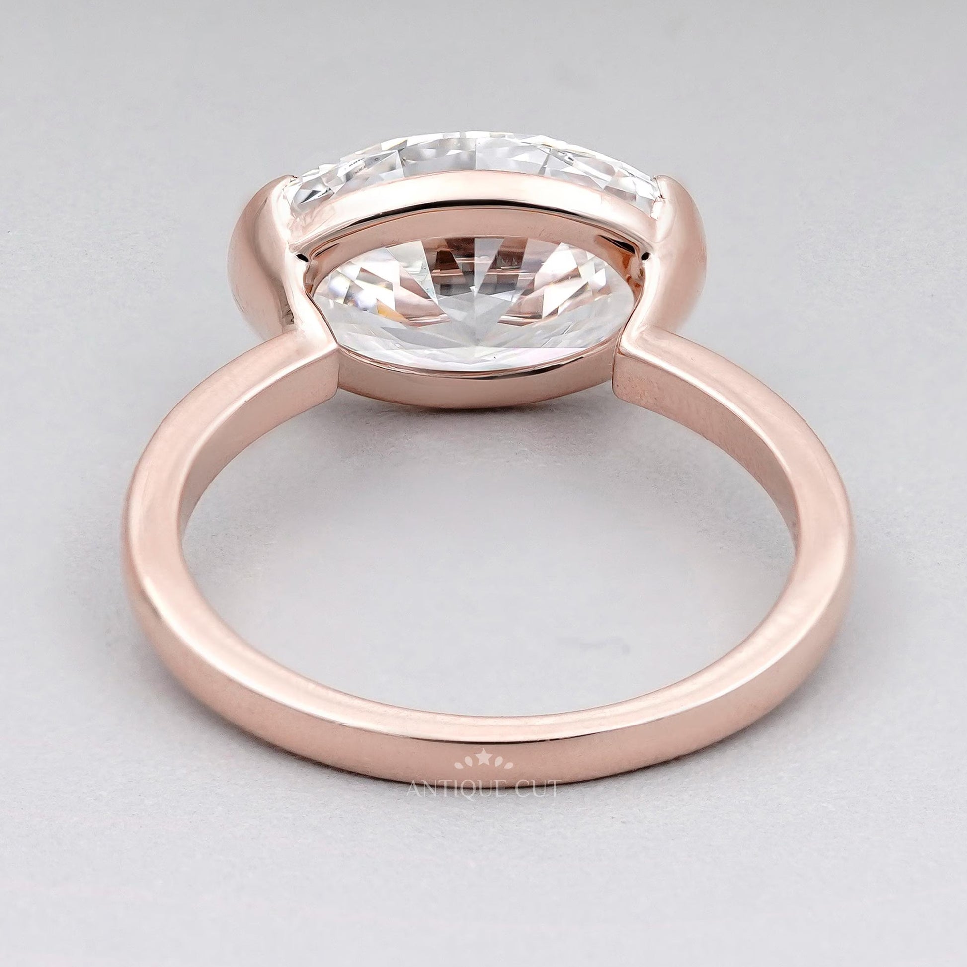Oval cut diamond ring with half bezel setting