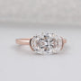 Rose gold ring with a large diamond on a light gray background