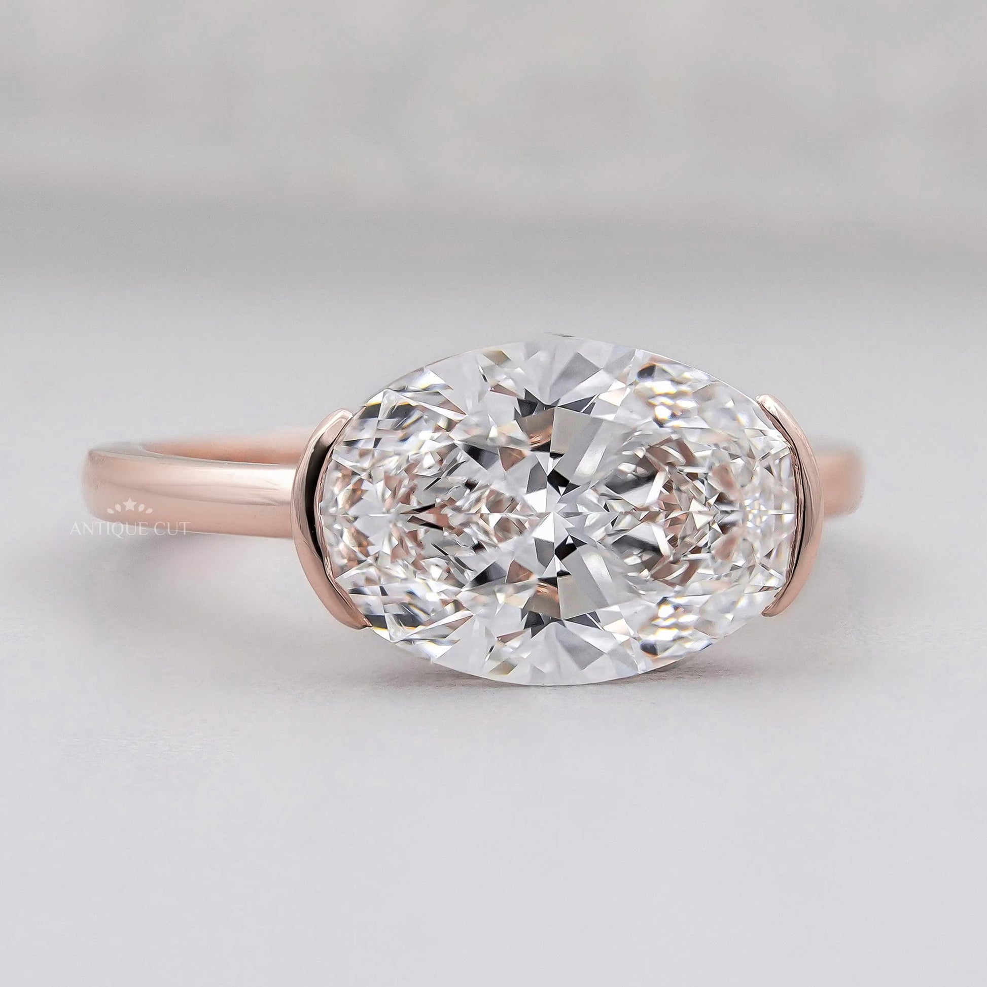 Horizontal oval diamond engagement ring in bezel design