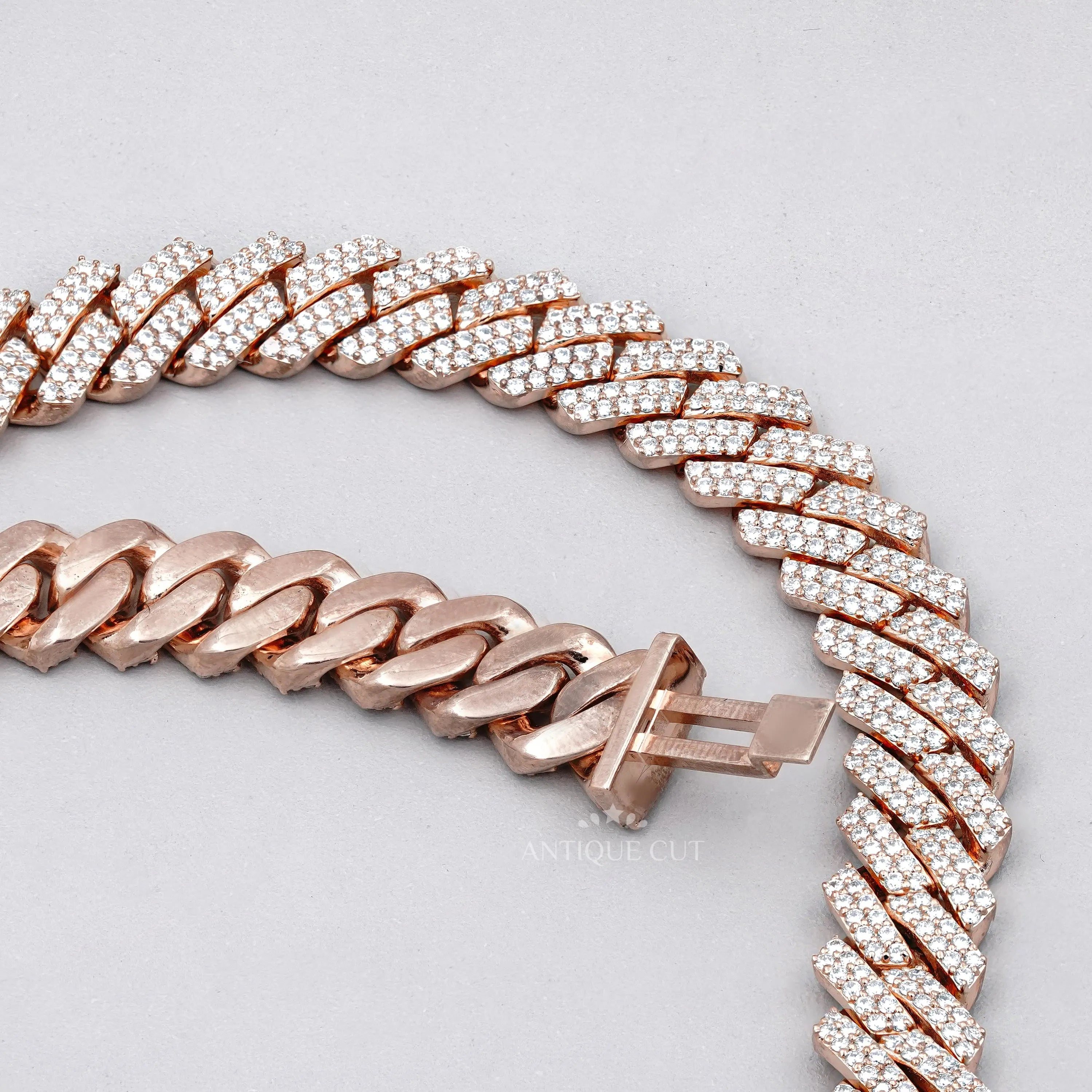 Rose gold chain necklace on a white surface