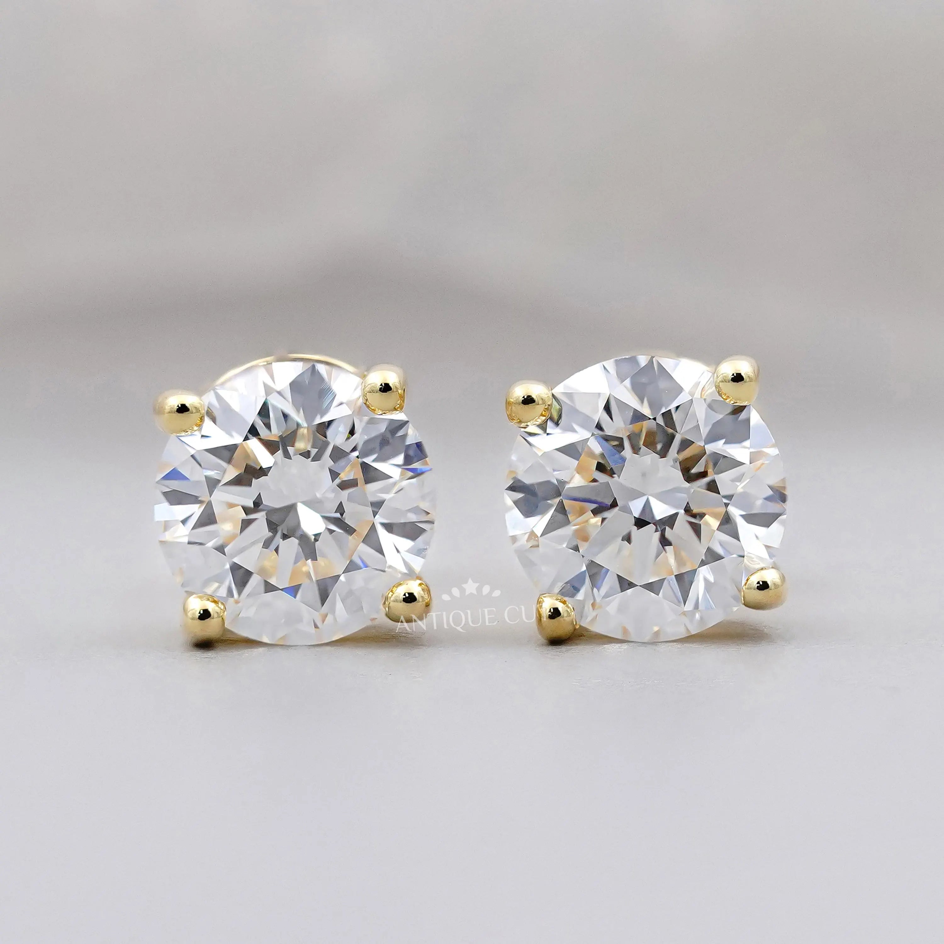 Pair of diamond stud earrings on a light gray background