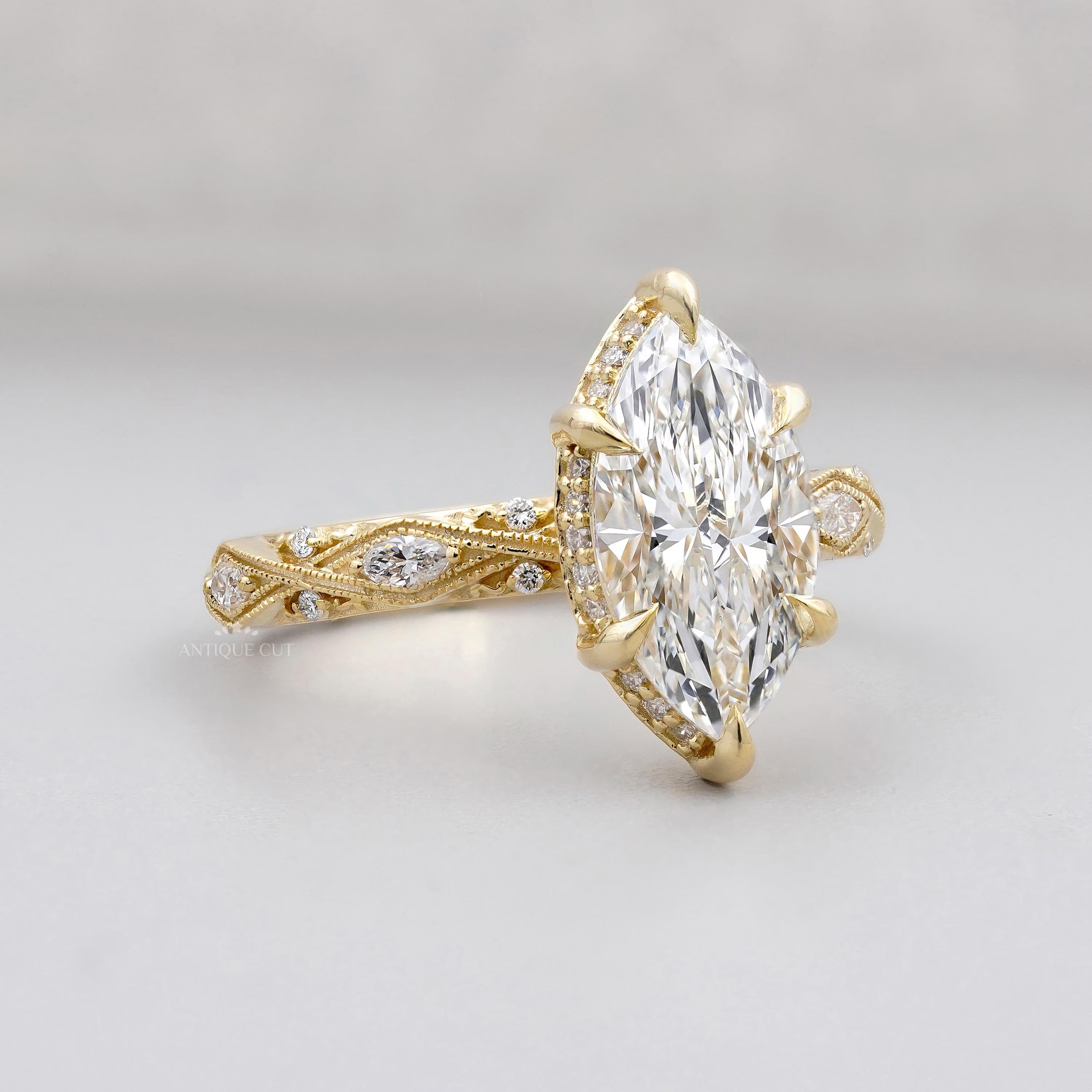 Gold ring with a large diamond on a light gray background