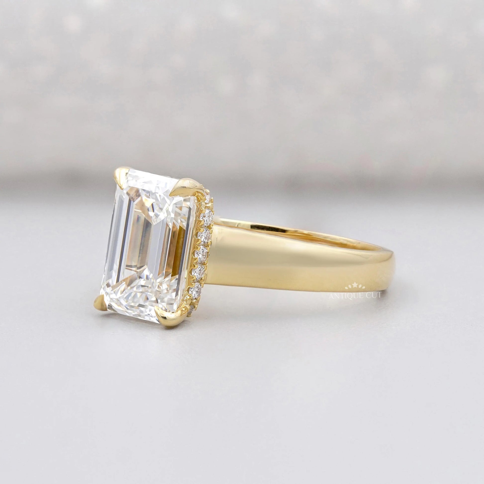 Yellow gold emerald cut engagement ring with hidden halo
