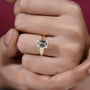Gold ring with a large diamond on a person's finger
