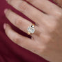 Gold ring with a large diamond on a person's finger