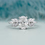 Oval cut diamond with marquise side stone engagement ring