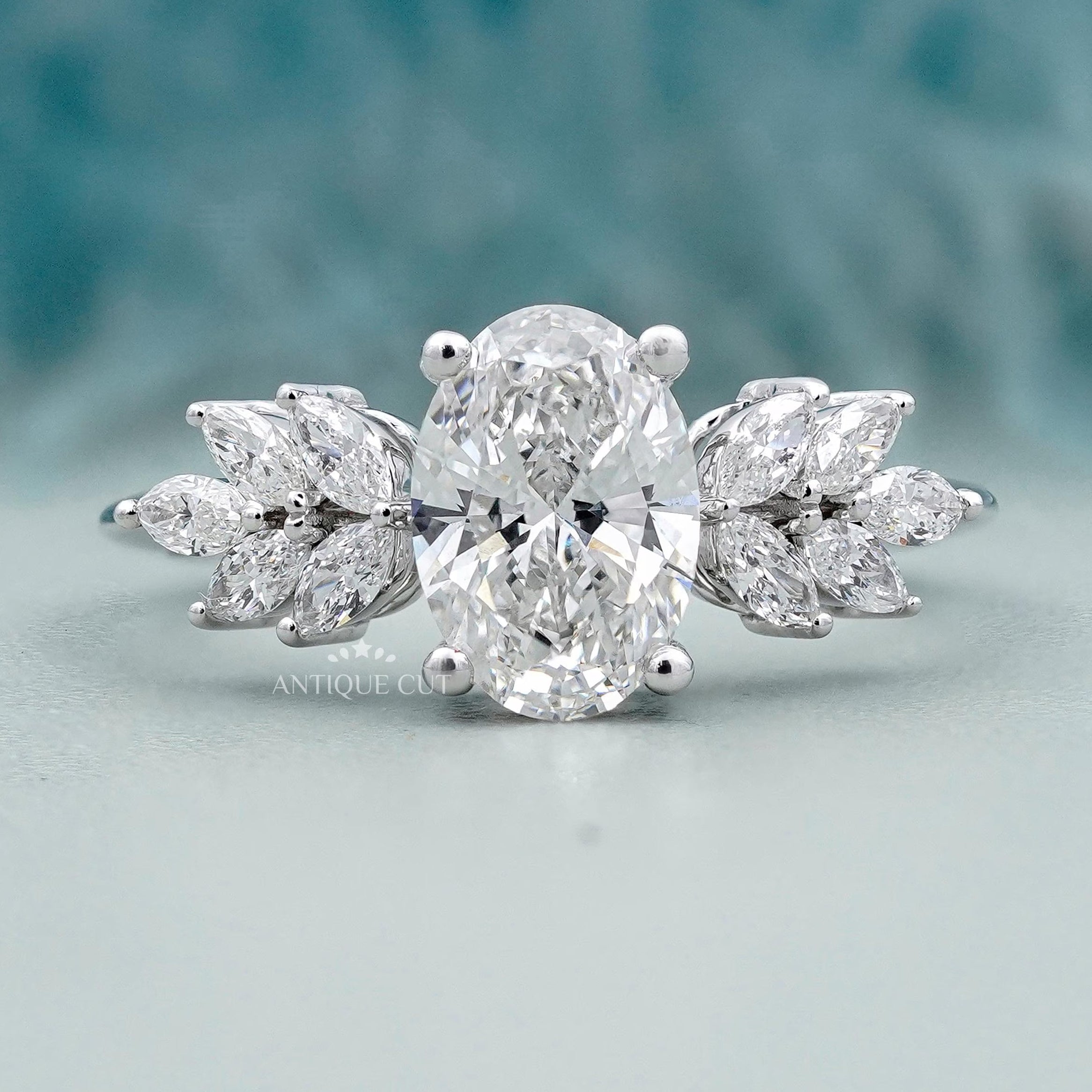 Oval cut diamond engagement ring with marquise side stones
