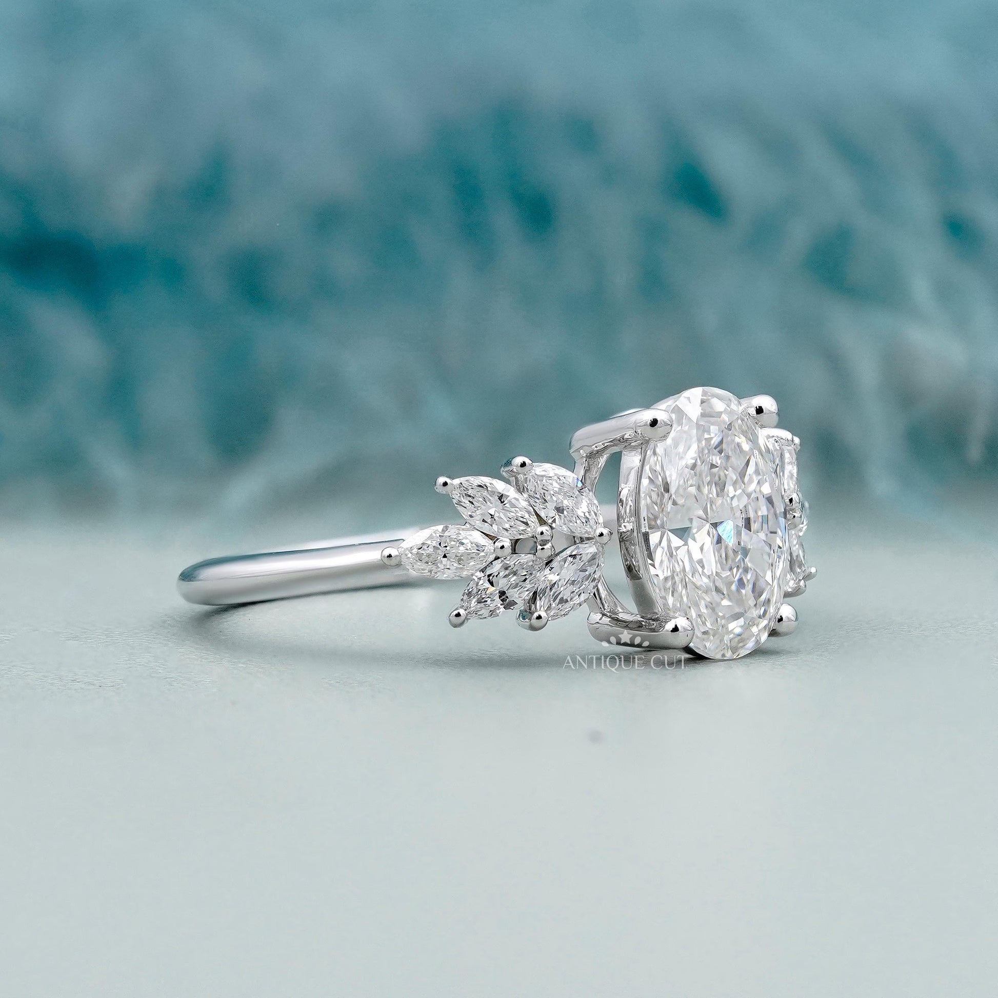 Oval cut lab grown diamond ring with marquise side stones