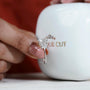 Diamond ring held by a hand with a antiqueCut jewelry box 