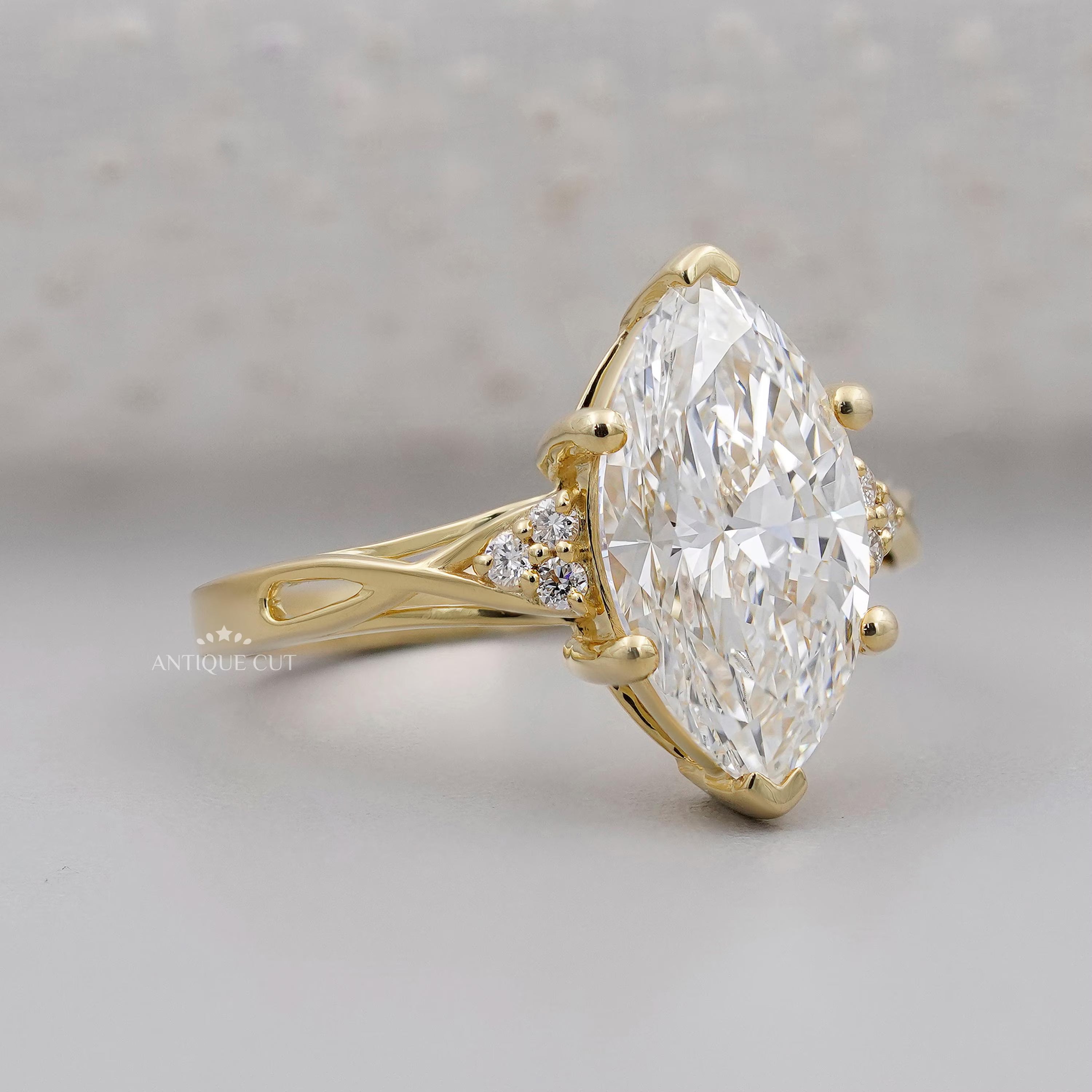 Gold ring with a large diamond on a gray background