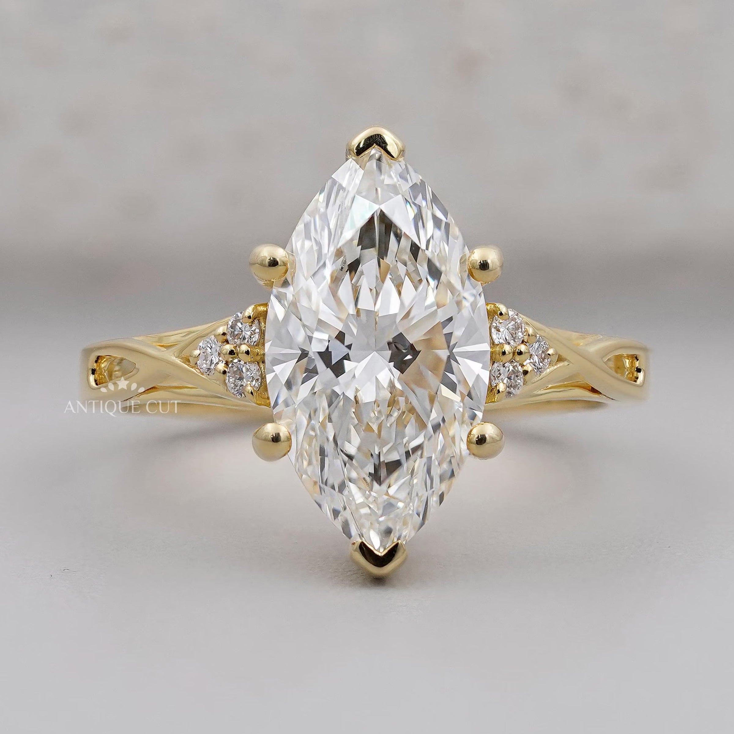 Marquise diamond engagement ring with round diamond side stones