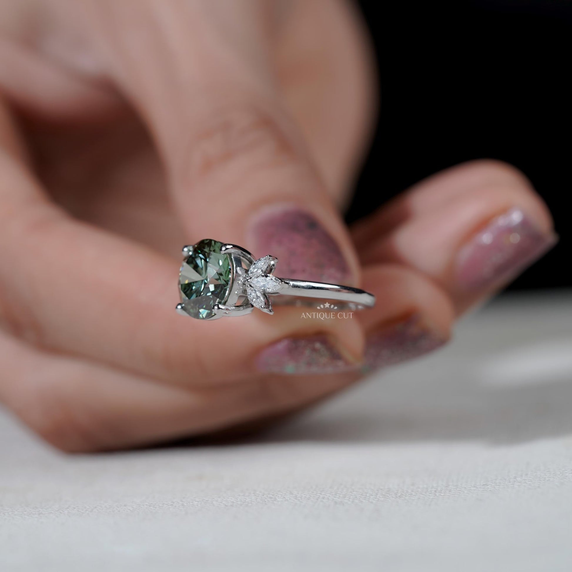 Round green diamond ring with marquise side stones