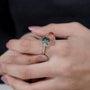4 prong round green diamond ring with side stones